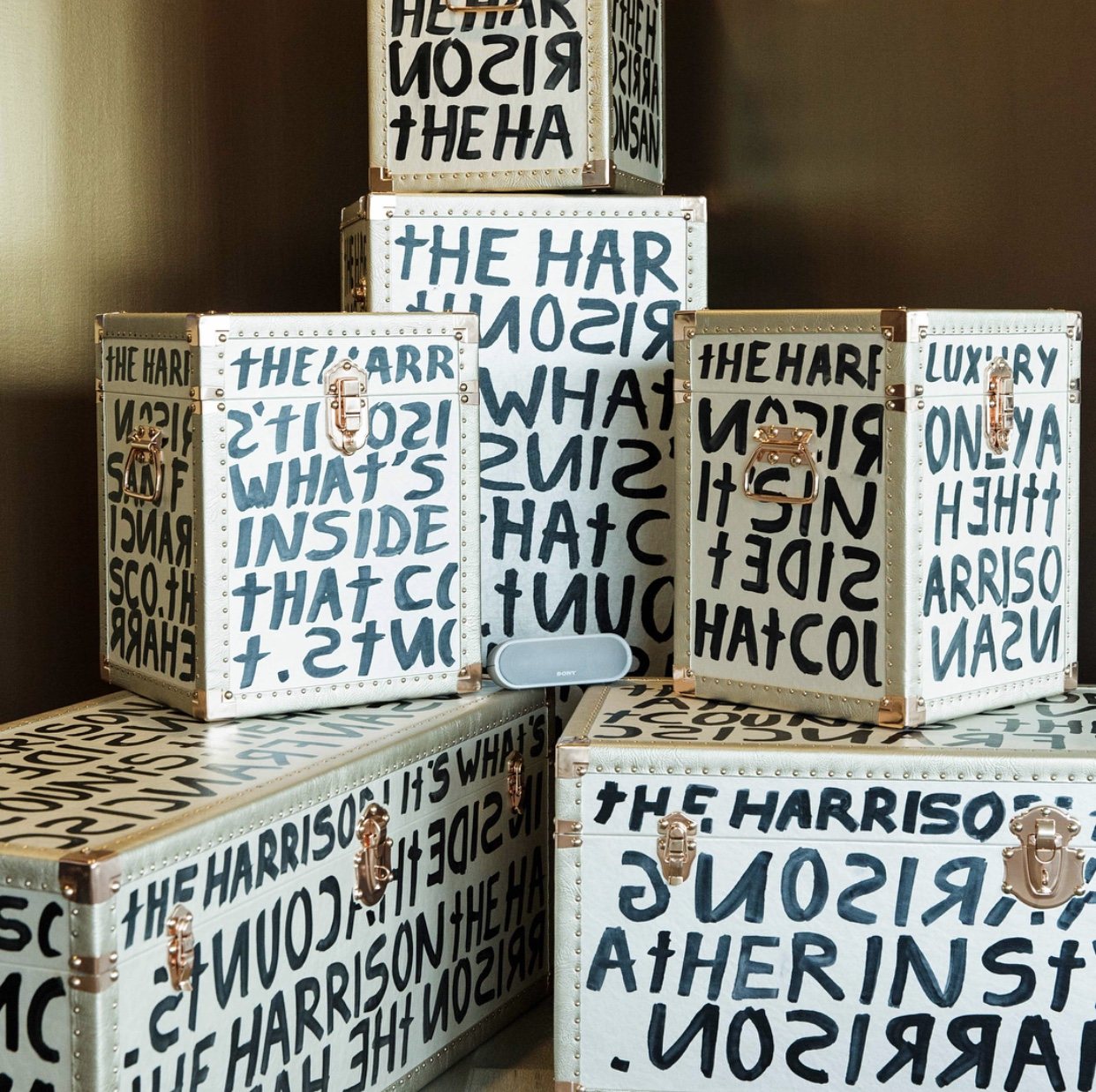 Stack of white trunks hand-lettered in black